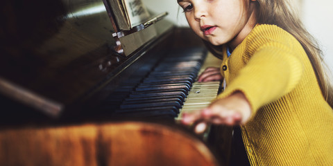 Adorable Cute Girl Playing Piano Concept