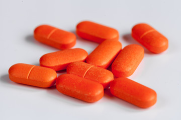 orange pills on a white background