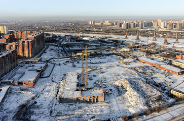 Tyumen, Russia - December 2, 2015: Aerial view on Tychkovka residential district, construction site of residential house, plant on production of prestarting heaters of engine and Tyumen river port