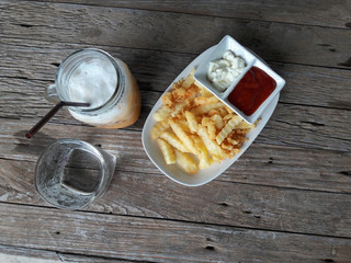 Top view French fries and Iced milk tea.