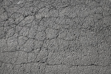 Tarmac. Cracked dark road pavement