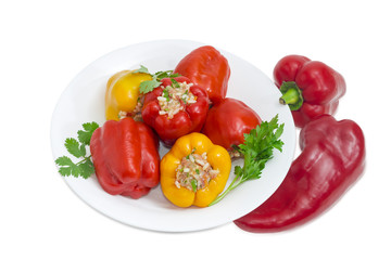 Stuffed bell peppers on white dish on light background