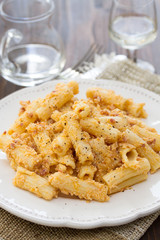pasta with sauce and black pepper on white plate
