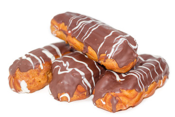Eclairs with whipped cream and chocolate icing closeup