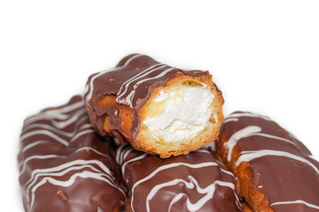 Eclairs with whipped cream and chocolate icing closeup