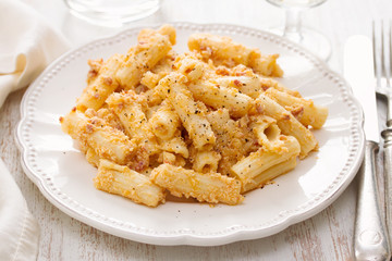 pasta with sauce and black pepper on white plate