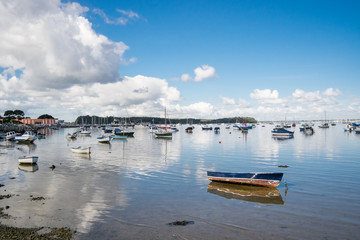 Fototapeta premium A calm scene of Poole harbour with many boats and blue sky with few clouds.