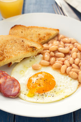 fried egg with beans, smoked sausage and toasts