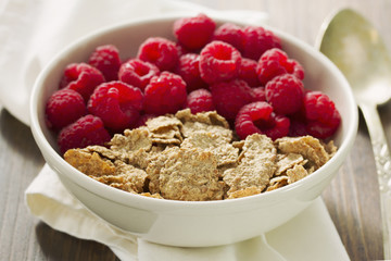 cereals with berries on white bowl