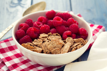 cereals with berries on white bowl