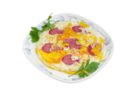 Omelette with sausage on a dish on a light background