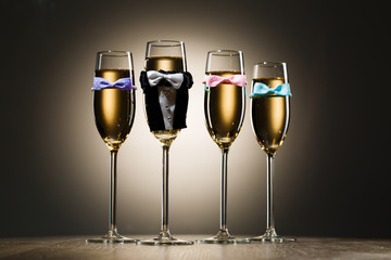 Glasses of champagne dressed in wedding suit and bow tie