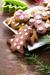Colorful Christmas gingerbread cookies on wooden background