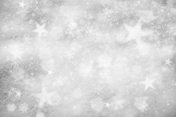 Artistic snow texture background with illustrated soft silver color snowflakes and star shapes background. Dreamy Christmas and New Year Holidays snow copy space background.