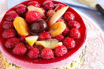 Close-up of jellied fruit and berries over delicious cake
