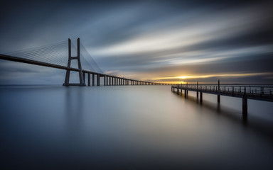 Fototapeta na wymiar Blue sunrise at Vasco da Gama Bridge in Lisbon