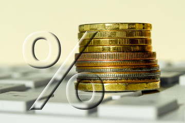 percent sign on a background of money and keyboard. The concept of financial transactions via the Internet