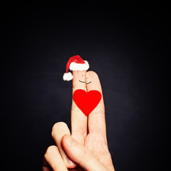 Christmas Couple. Happy Couple Fingers in Santa Hat with Heart