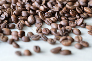 Roasted coffee beans on a wooden background