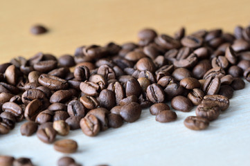 Roasted coffee beans on a wooden background