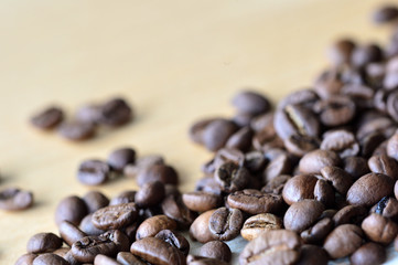 Roasted coffee beans on a wooden background