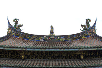 Chinese temple roof. Two dragons on each side, one tower in the center, phoenix, elephant and other historical characters along the edge of the roof painted red, yellow, blue, green and white.