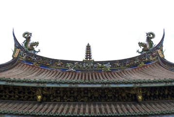 Fototapeta premium Chinese temple roof. Two dragons on each side, one tower in the center, phoenix, elephant and other historical characters along the edge of the roof painted red, yellow, blue, green and white.