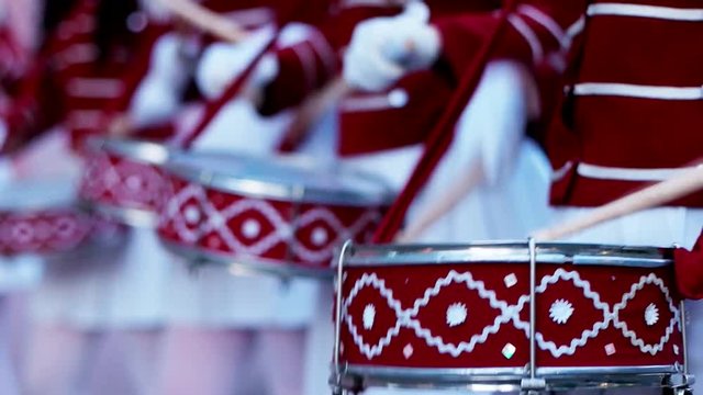 Drummers of Orchestra of Military Music College at Music Festival. A company of girls-drummers stands in the city In a beautiful festive form, musicians pounding drumsticks on a drum