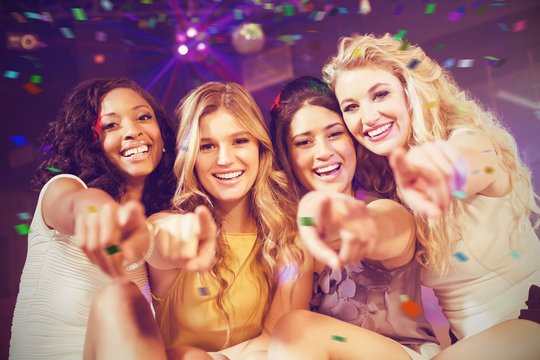 Composite image of pretty girls pointing with finger