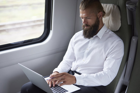 Modern businessman working in the train
