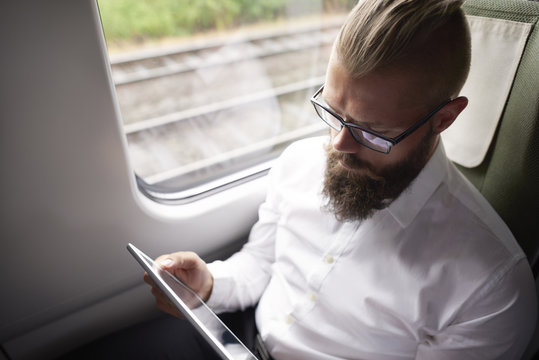 Business with long beard working during the travel