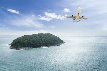 Fototapeta na wymiar passenger plane flying with beautiful tropical island.