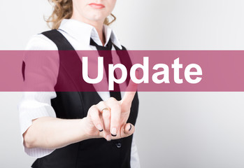 update written on virtual screen. technology, internet and networking concept. woman in a black business shirt presses button on virtual screens