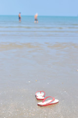 Flipflops on a sandy ocean beach, Vacation concept