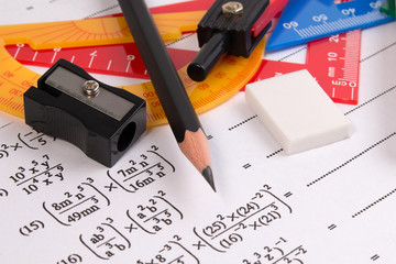 Math quadratic equation concepts. School supplies used in math. Math drawing tools with math equipment. Math exercise sheet with school supplies.