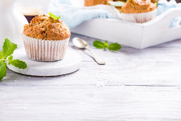 Delicious homemade coconut cinnamon muffin on marble coasters. Healthy food concept with copy space.