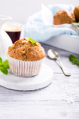 Delicious homemade coconut cinnamon muffin on marble coasters. Healthy food concept with copy space.