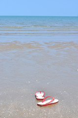 Flipflops on a sandy ocean beach, Vacation concept