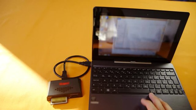 Laptop computer with card reader plugged 4K
