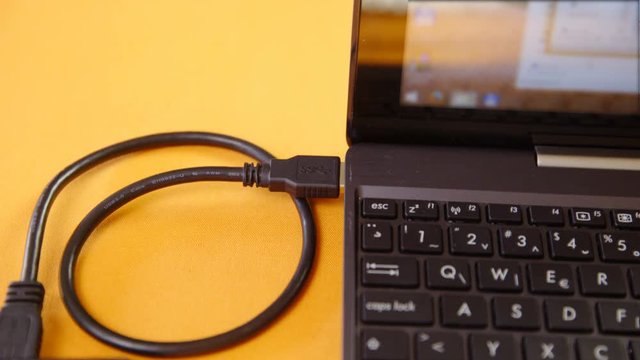 Plug-in USB device to computer closeup 4K
