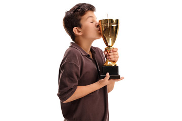 Boy kissing a gold trophy