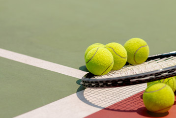 Tennis Ball with Racket on the clay tennis court