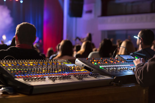 Soundman working on the mixing console.