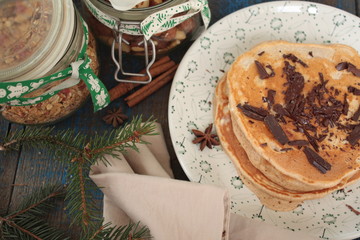 Christmas pancakes from whole wheat flour with chocolate and butter, nuts, muesli, milk. nutritious, healthy, festive Breakfast