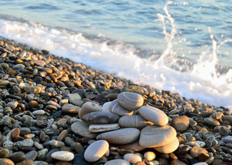 slide stones illuminated by the sun is on the pebbly sea beach,