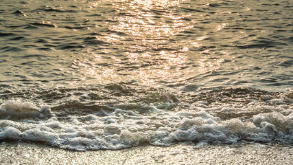 Sea surf with sunset light