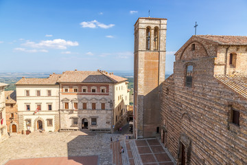 Fototapeta na wymiar Montepulciano, Italy. A large Square: in the center - Palace Contucci, right - Bell Tower (XV c.) and the Cathedral of the Assumption of the Virgin Mary, 1592 - 1630