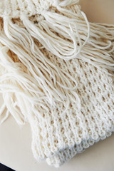 warm White knit scarf with tassels. Close