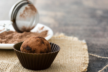 Homemade chocolate truffles on wooden table

