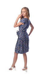 Young pretty long haired blonde woman posing in fashion dress on white background in a studio. Spring summer photo, catalog collection.